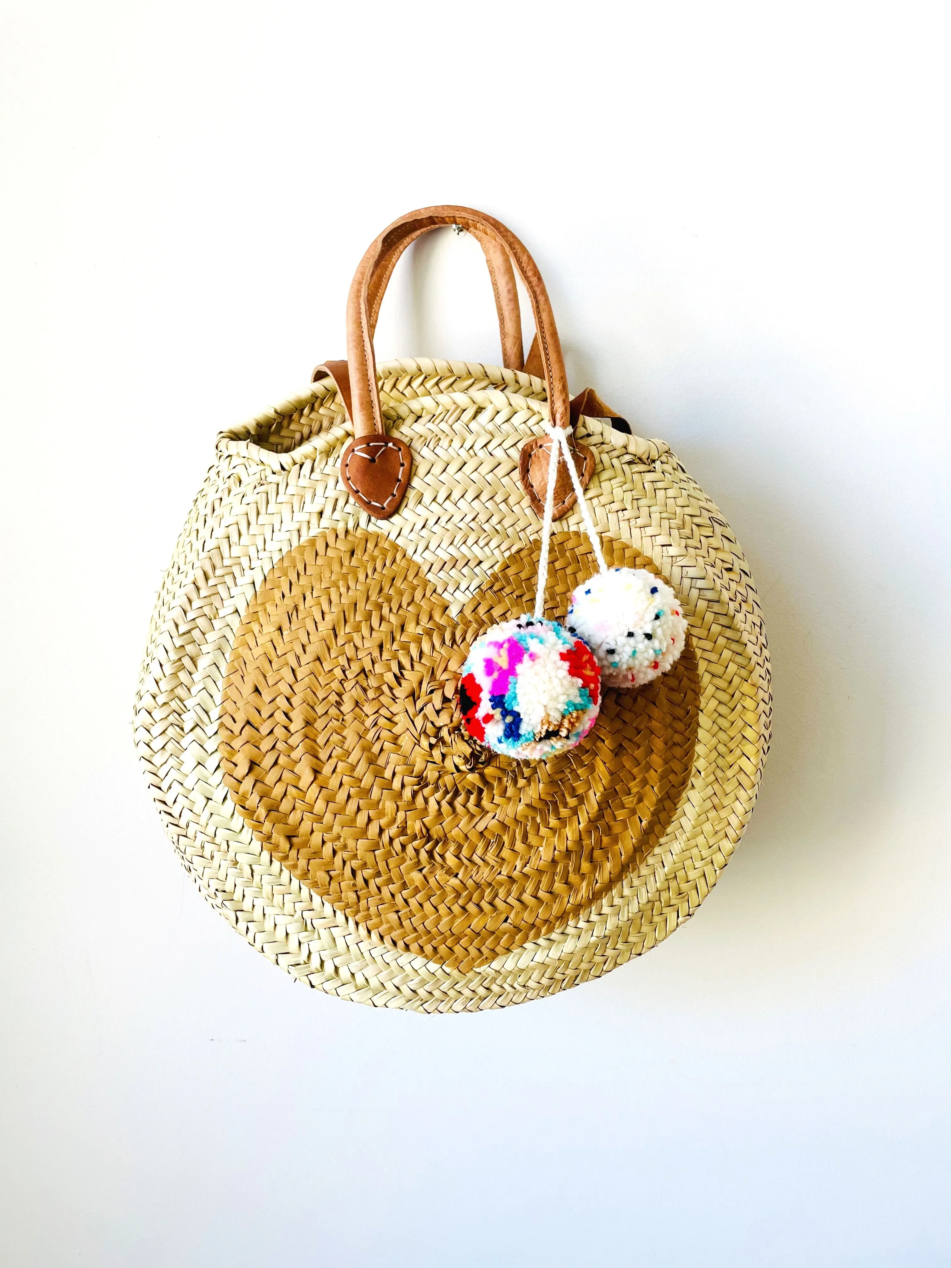 Round  Straw Bag with Leather Straps and Poms by Poppy Joy Pompoms